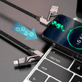 4-in-1 fast charging cable charging a phone beside a laptop